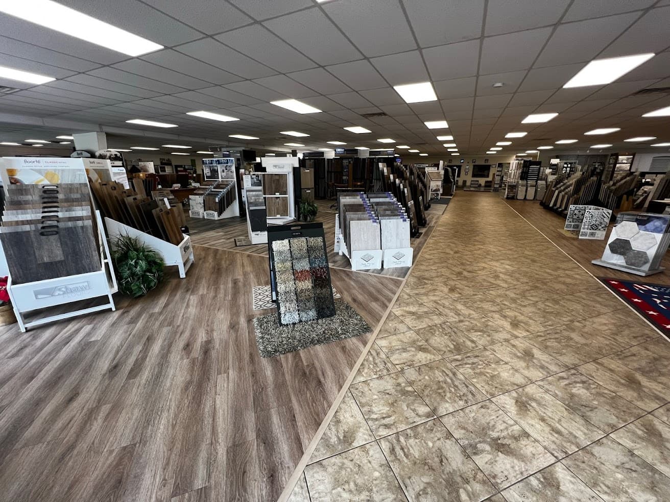 Flooring sample racks and swatch displays inside the Blackburn's Interiors showroom in Winter Haven, where wood-look vinyl plank meets stone-look tile.