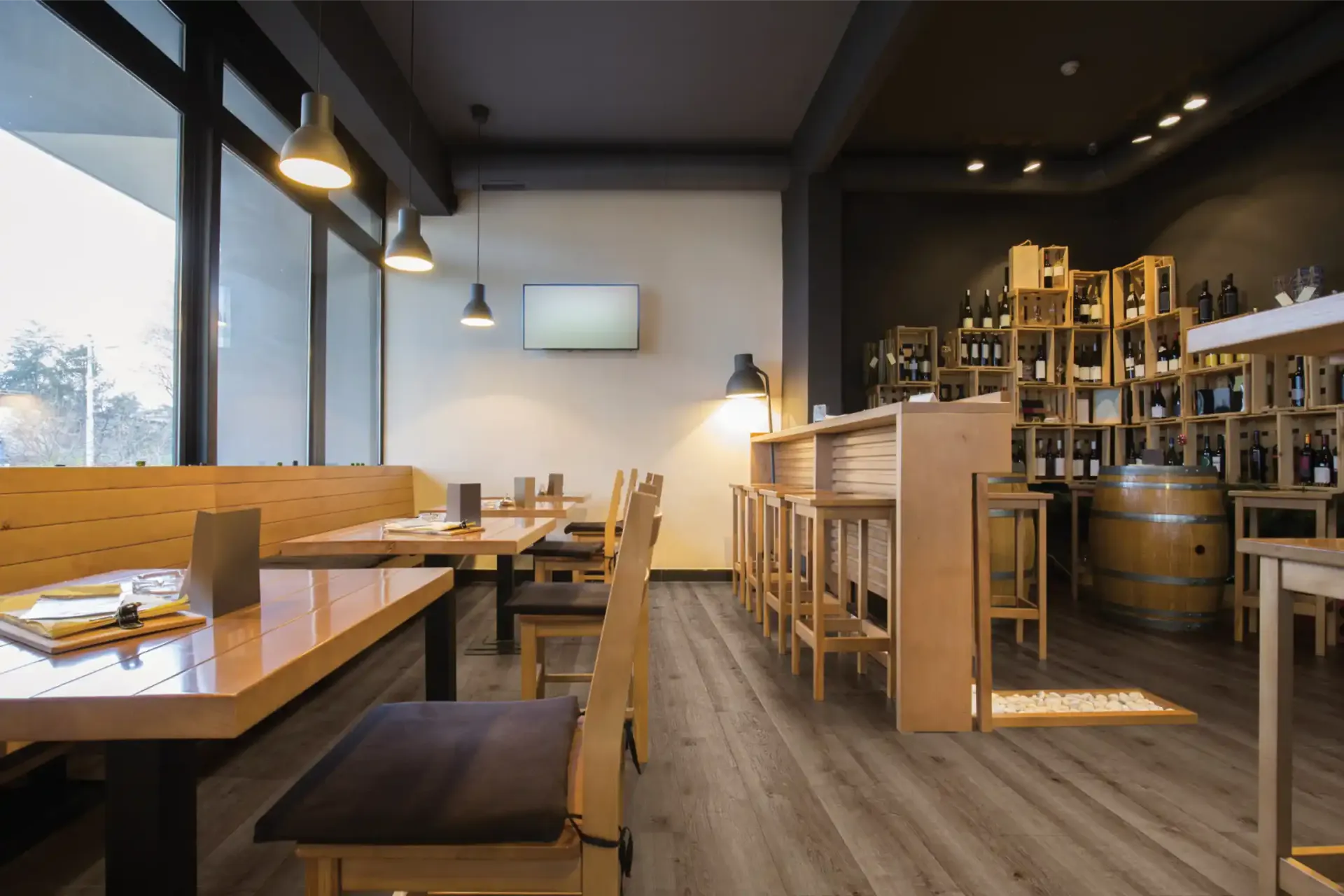 Gray wood-look luxury vinyl plank flooring in a busy dining space, a waterproof surface that stands up to dog claws