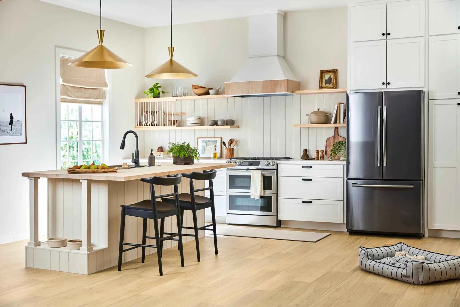 Waterproof luxury vinyl plank in a white Florida kitchen with a dog bed