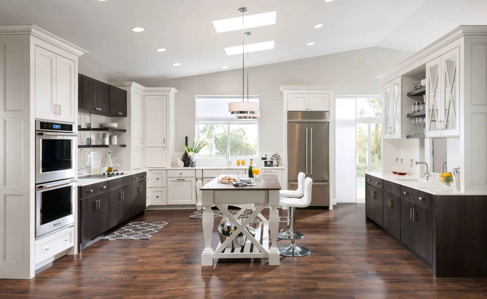 A white and dark contemporary kitchen with an island, from the Medallion cabinet line we carry