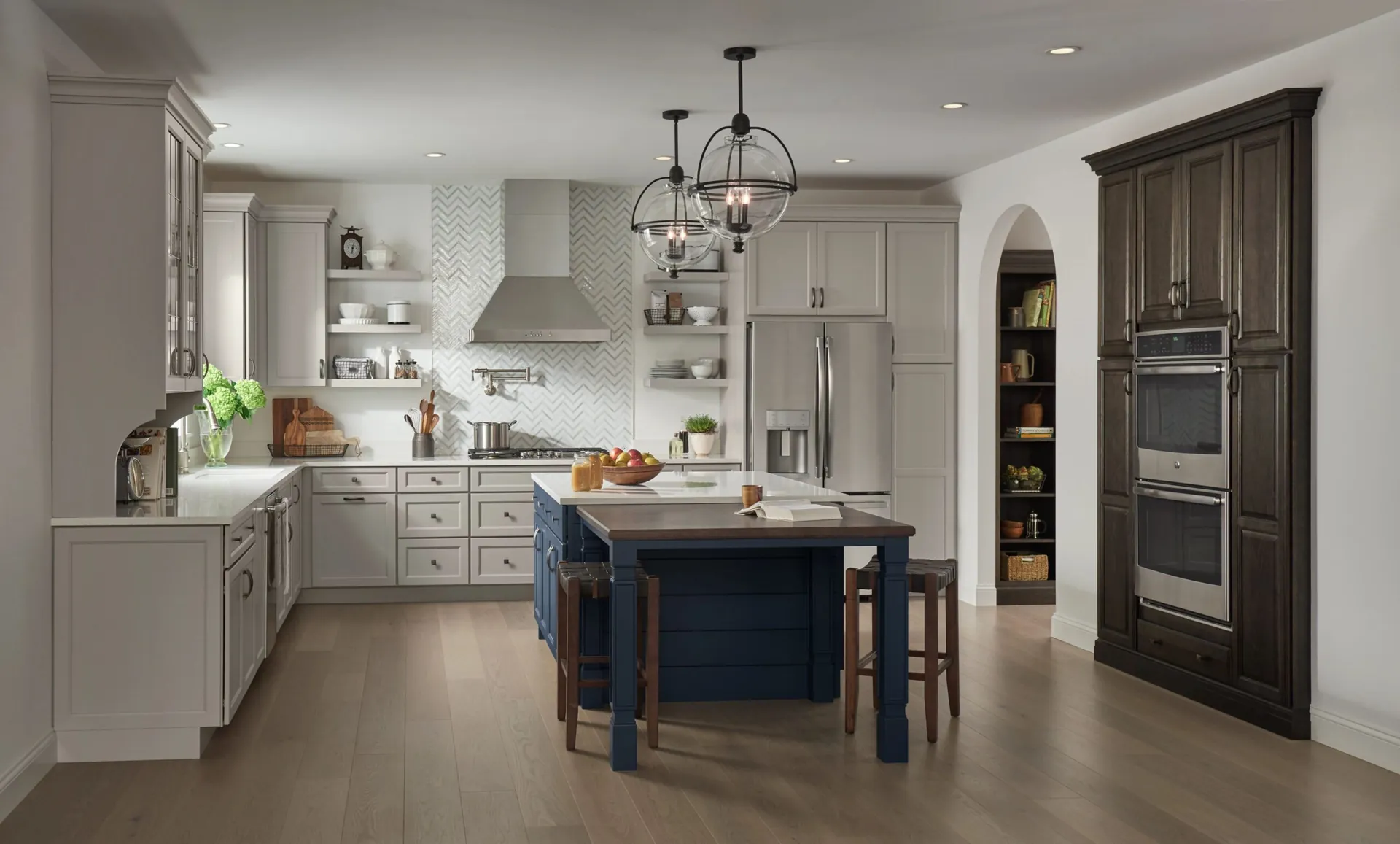 A white kitchen with a blue island, from the Medallion cabinet line we carry