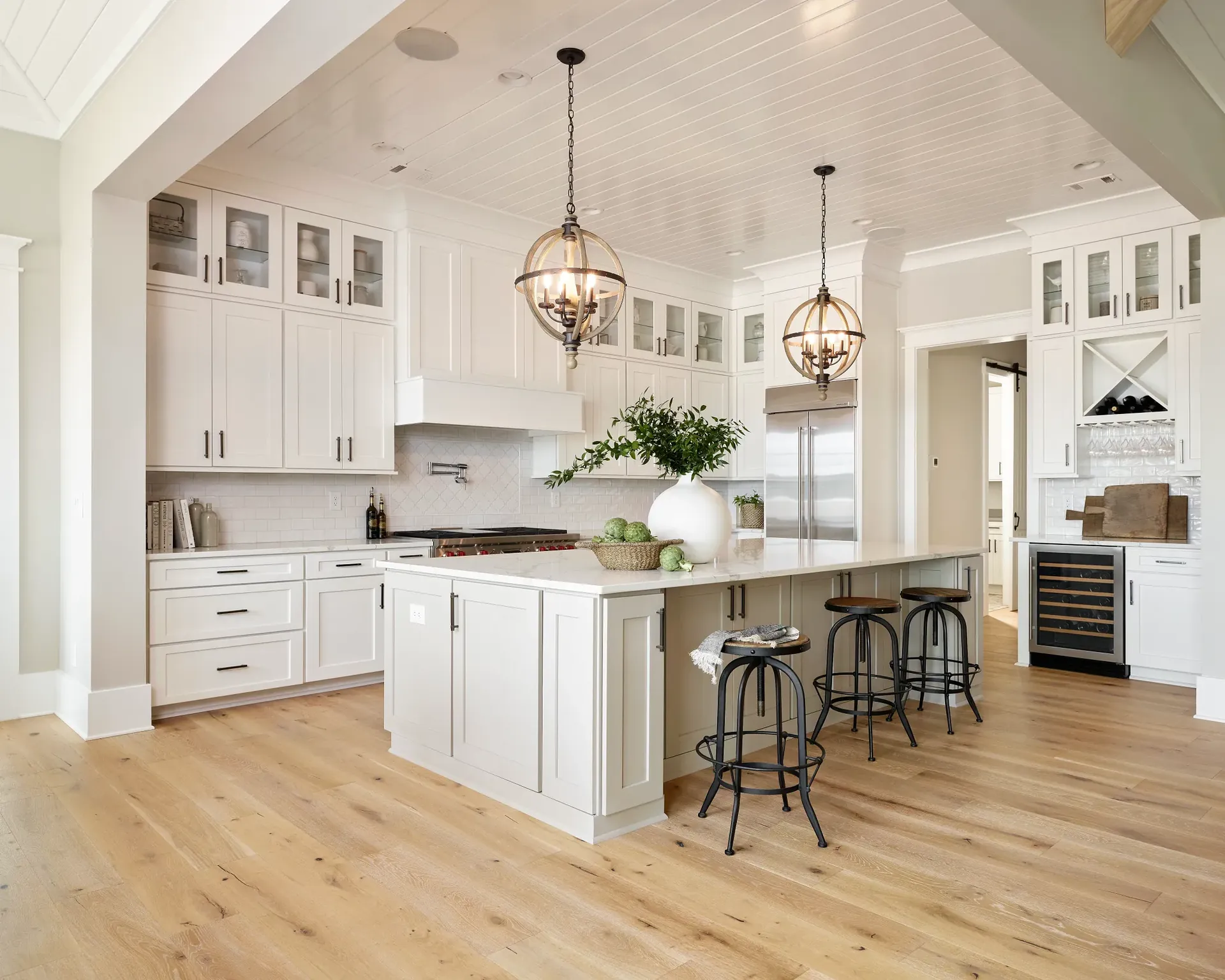 Light hardwood flooring from Shaw's Gallery collection in a modern white kitchen