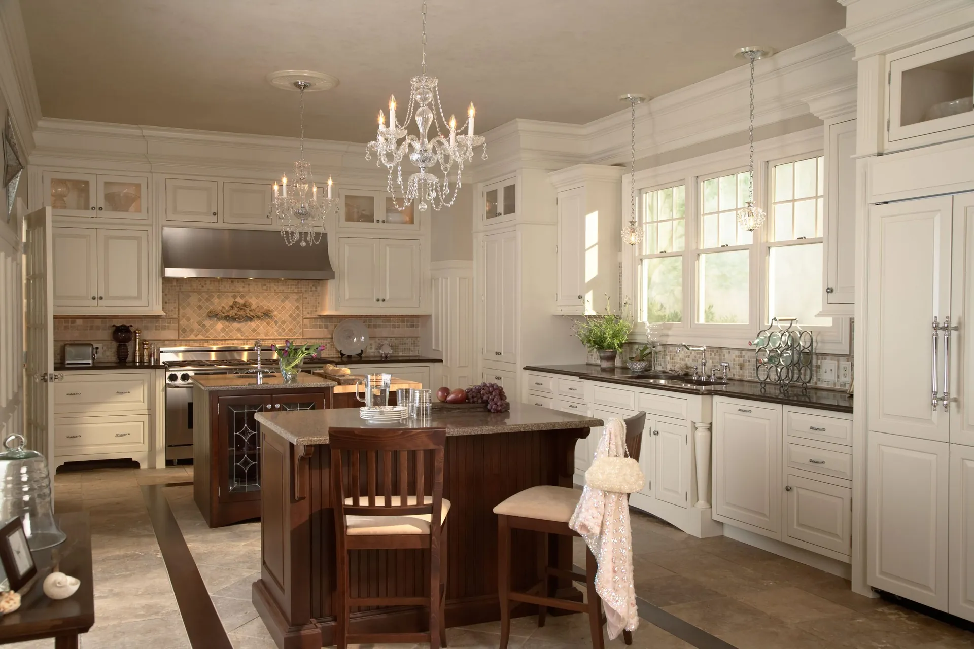 A traditional white kitchen with a wood island, from the Medallion cabinet line we carry