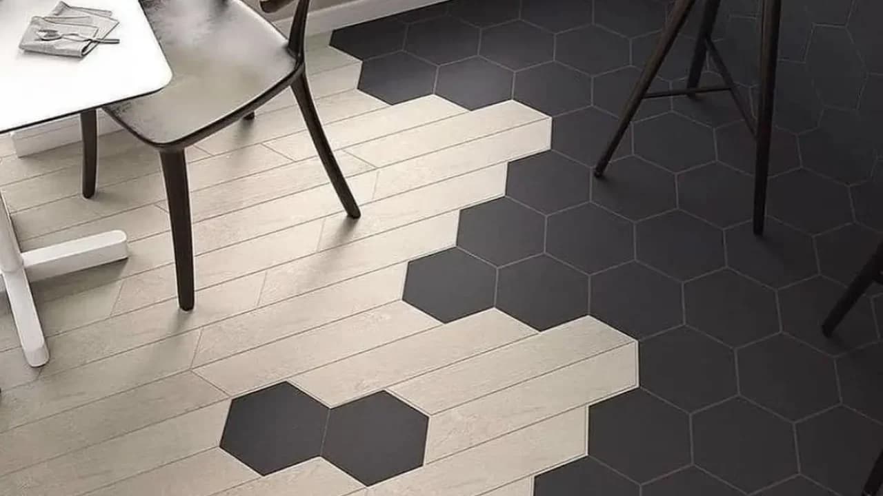 Creative floor design mixing light wood planks with dark hexagonal tile in a transitional kitchen pattern