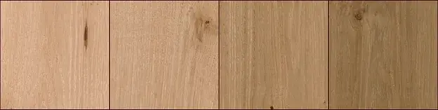 Close-up of four wide-plank white oak hardwood samples showing natural grain variation
