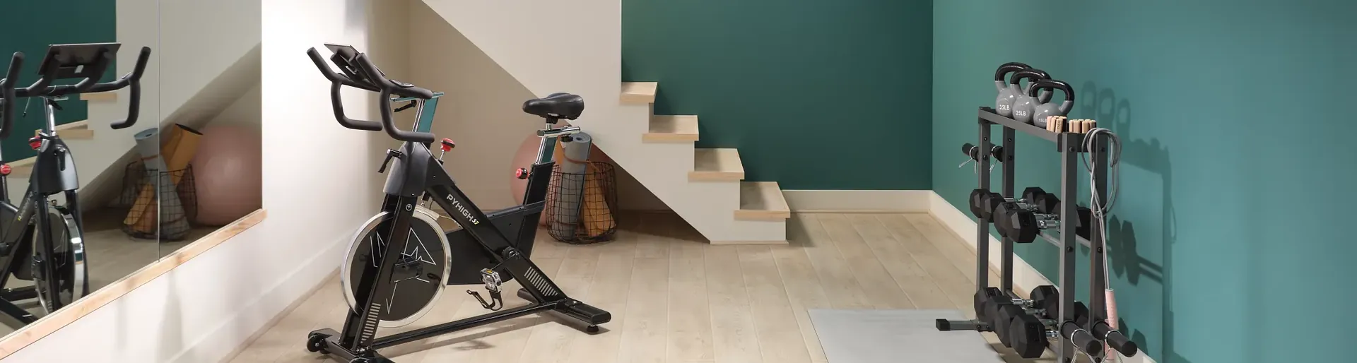 Light wood-look luxury vinyl plank flooring by COREtec Pro in a home gym