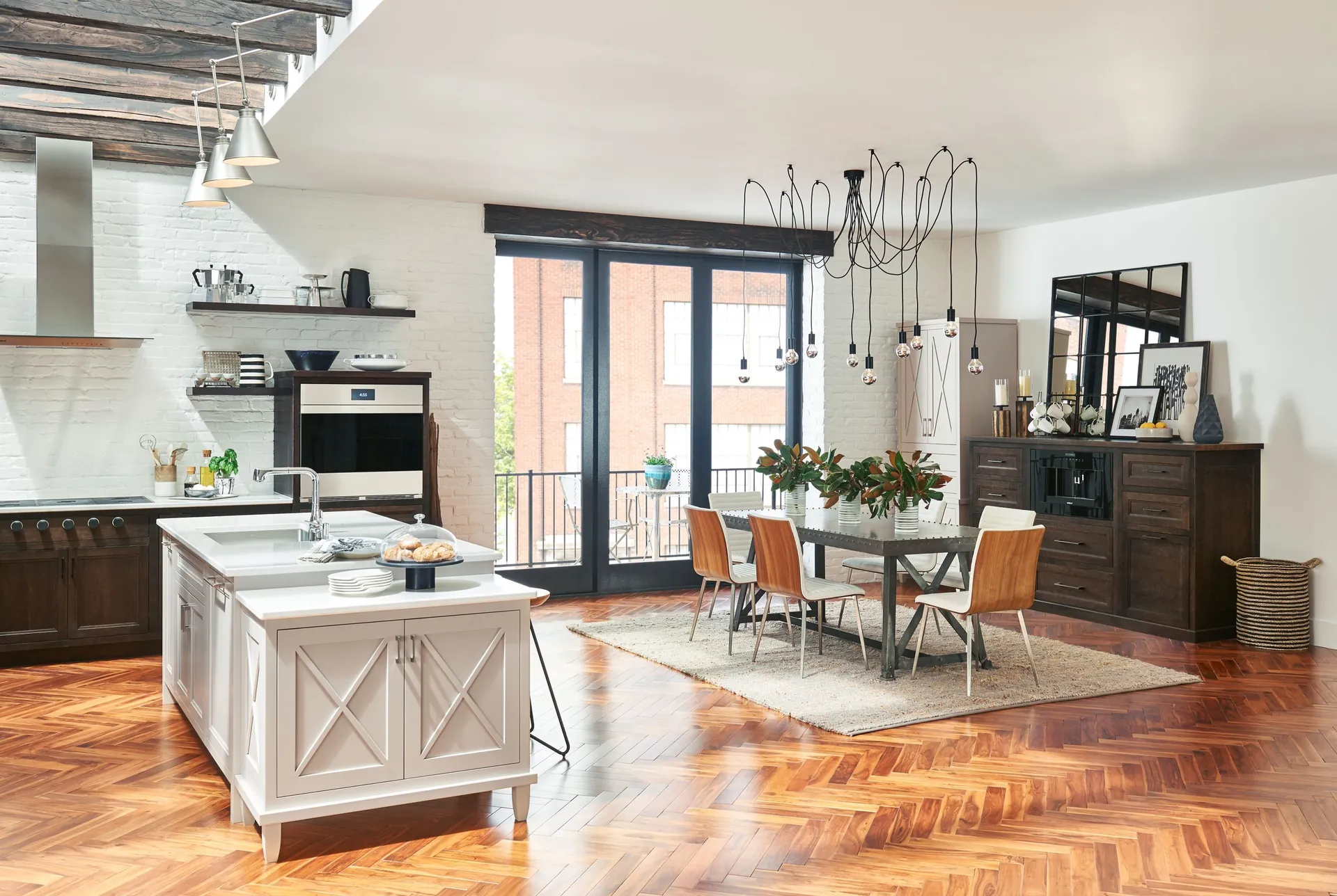 A white kitchen with an island and a dining area, from the Medallion cabinet line we carry