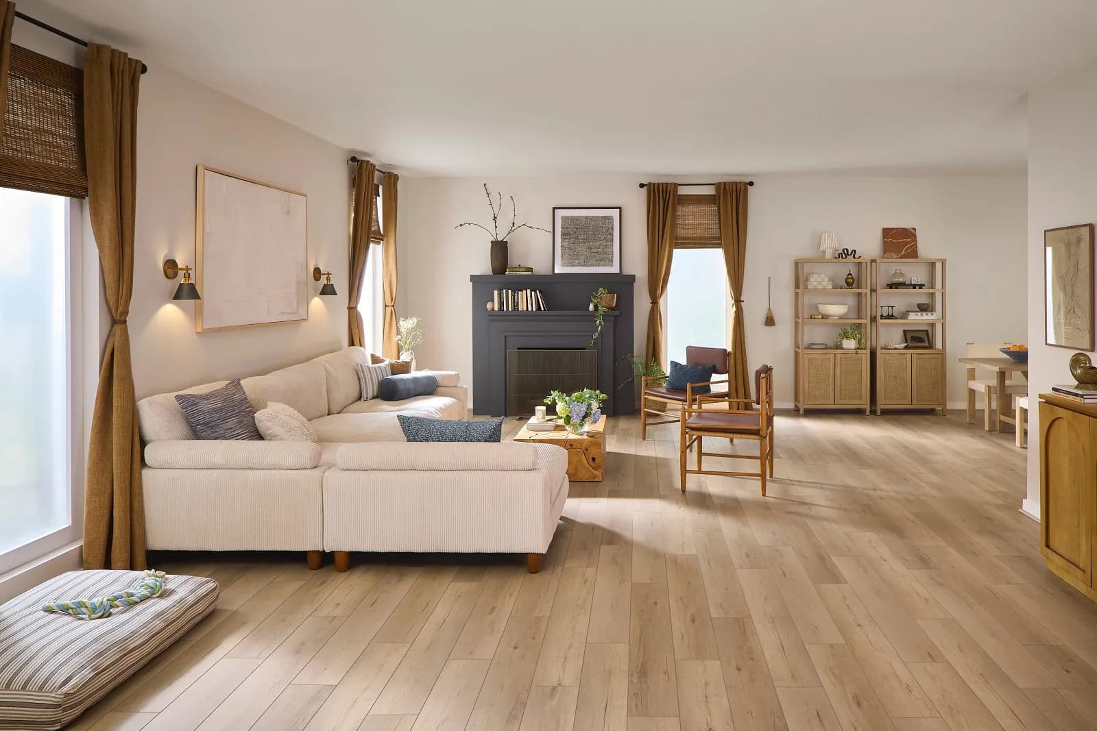 Warm light golden oak luxury vinyl plank flooring in an open living room, from the COREtec line we carry