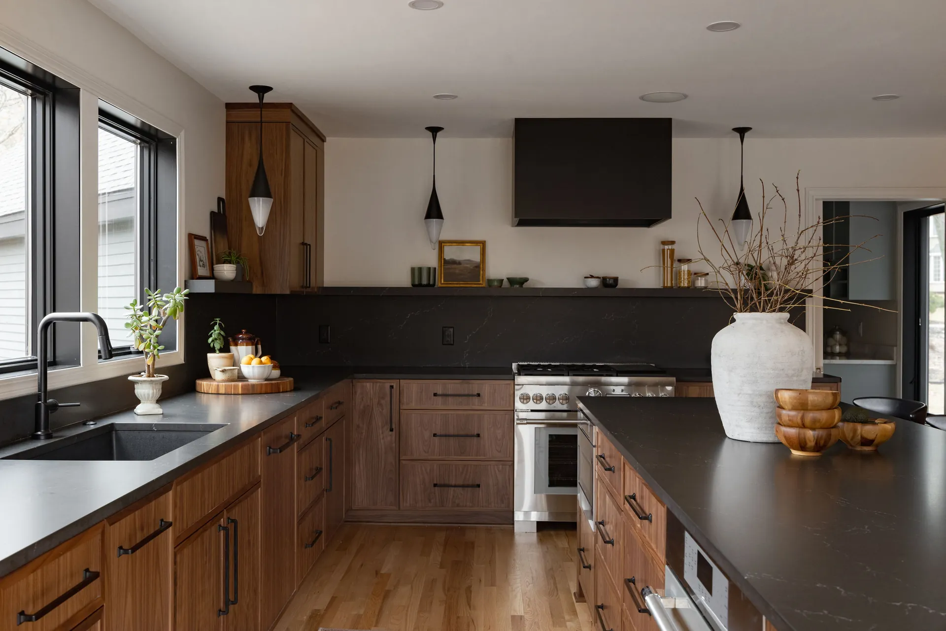 A kitchen with a wood island and dark countertops