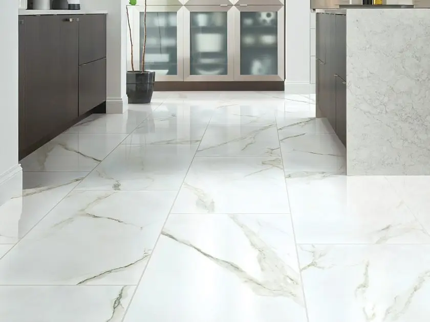 Large-format polished marble-look porcelain tile flooring in a contemporary kitchen with dark cabinets