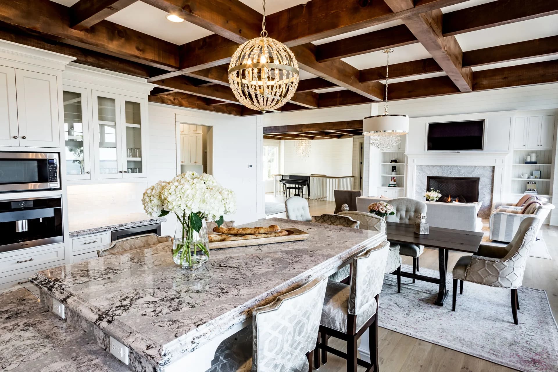 A kitchen with a dramatic veined quartz island, from the Cambria quartz line we carry