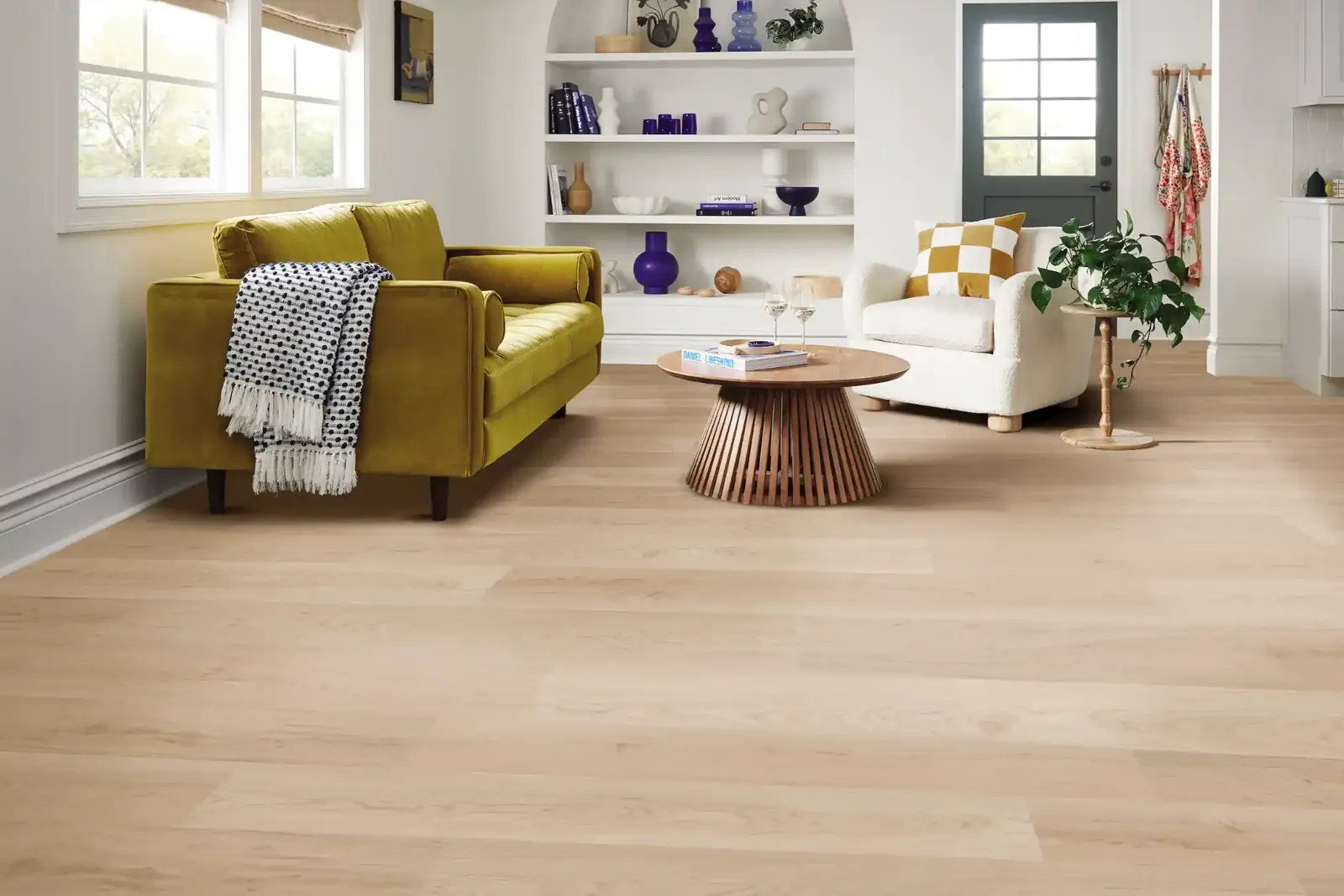 Pale blond luxury vinyl plank in a bright living room, showing how light floors make a small room feel bigger