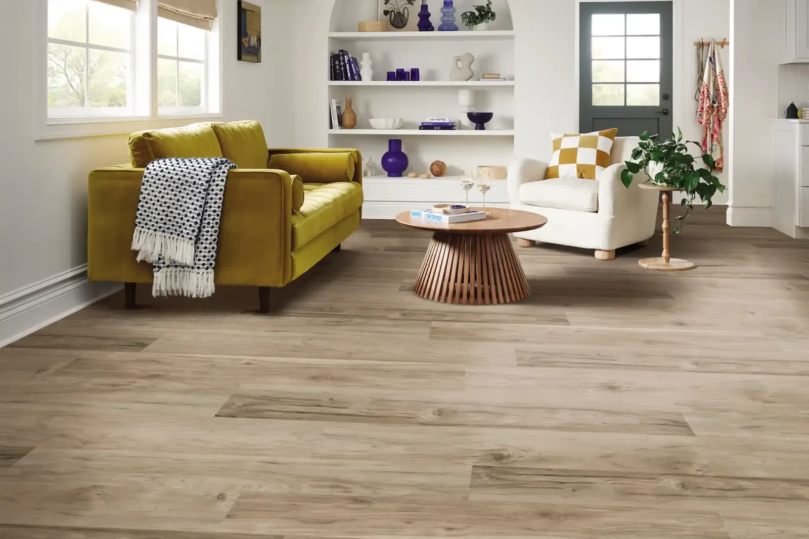 Wide greige luxury vinyl planks in the same living room, where cooler tones keep the space open