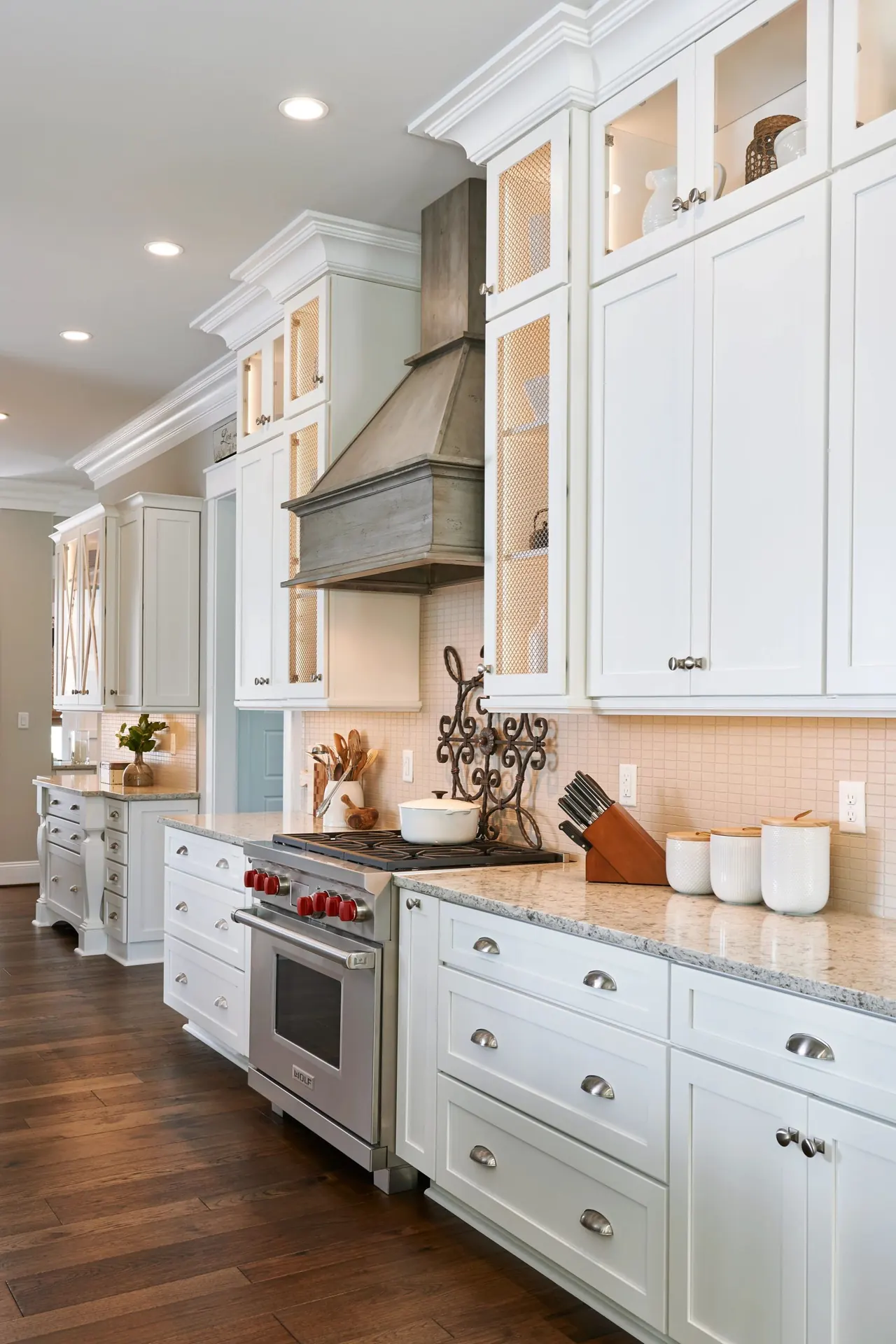 White shaker kitchen cabinets with round knobs on the doors and cup pulls on the drawers