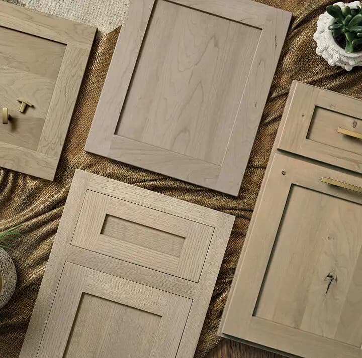 Shaker and recessed-panel kitchen cabinet door samples in warm natural wood, examples of the cabinet styles Blackburn's Interiors offers Bartow, FL homeowners, family-owned since 1962