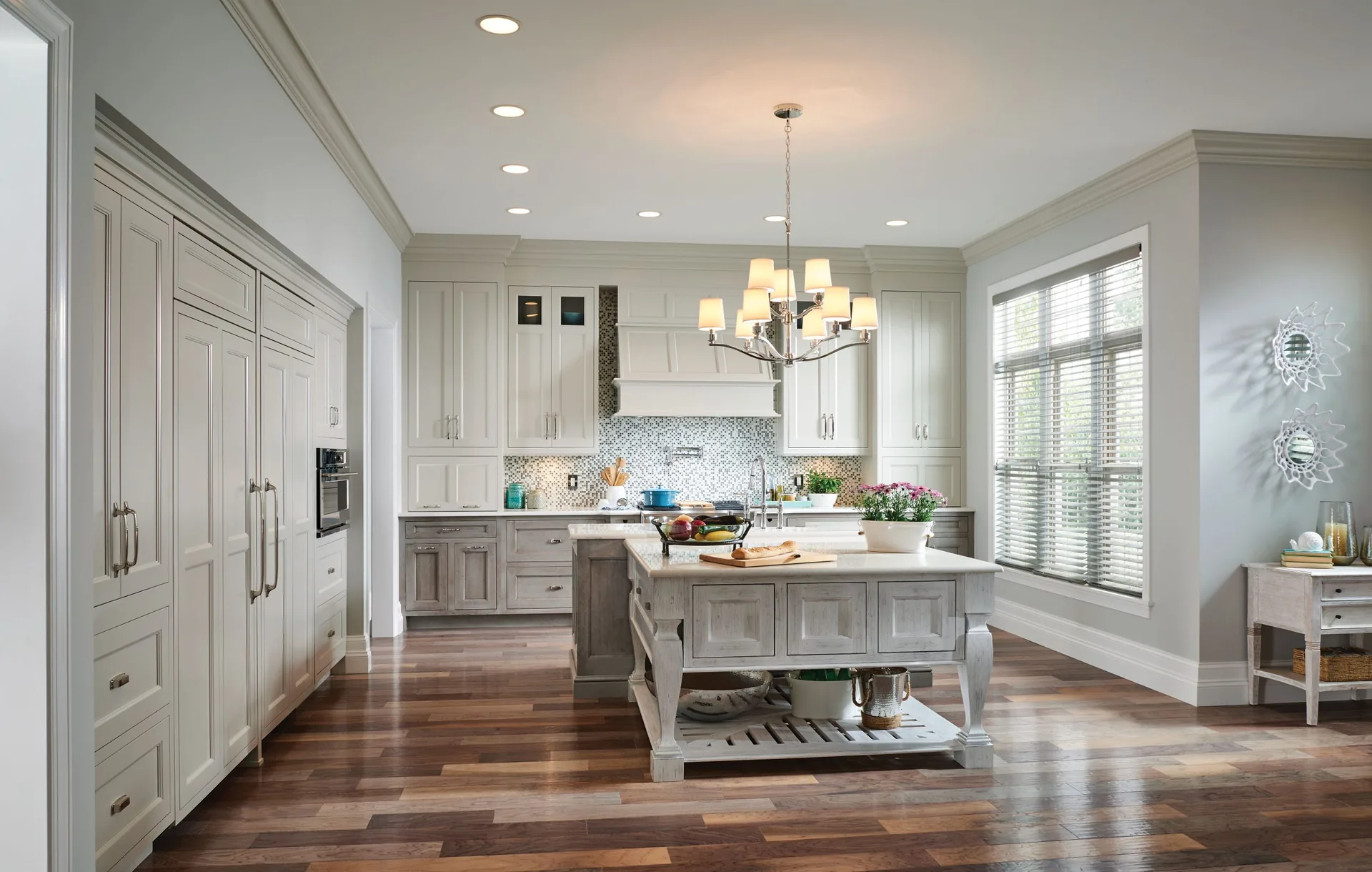 Medallion Providence raised panel cabinets in a painted white kitchen with a gray island, a Medallion kitchen scene from our cabinet line