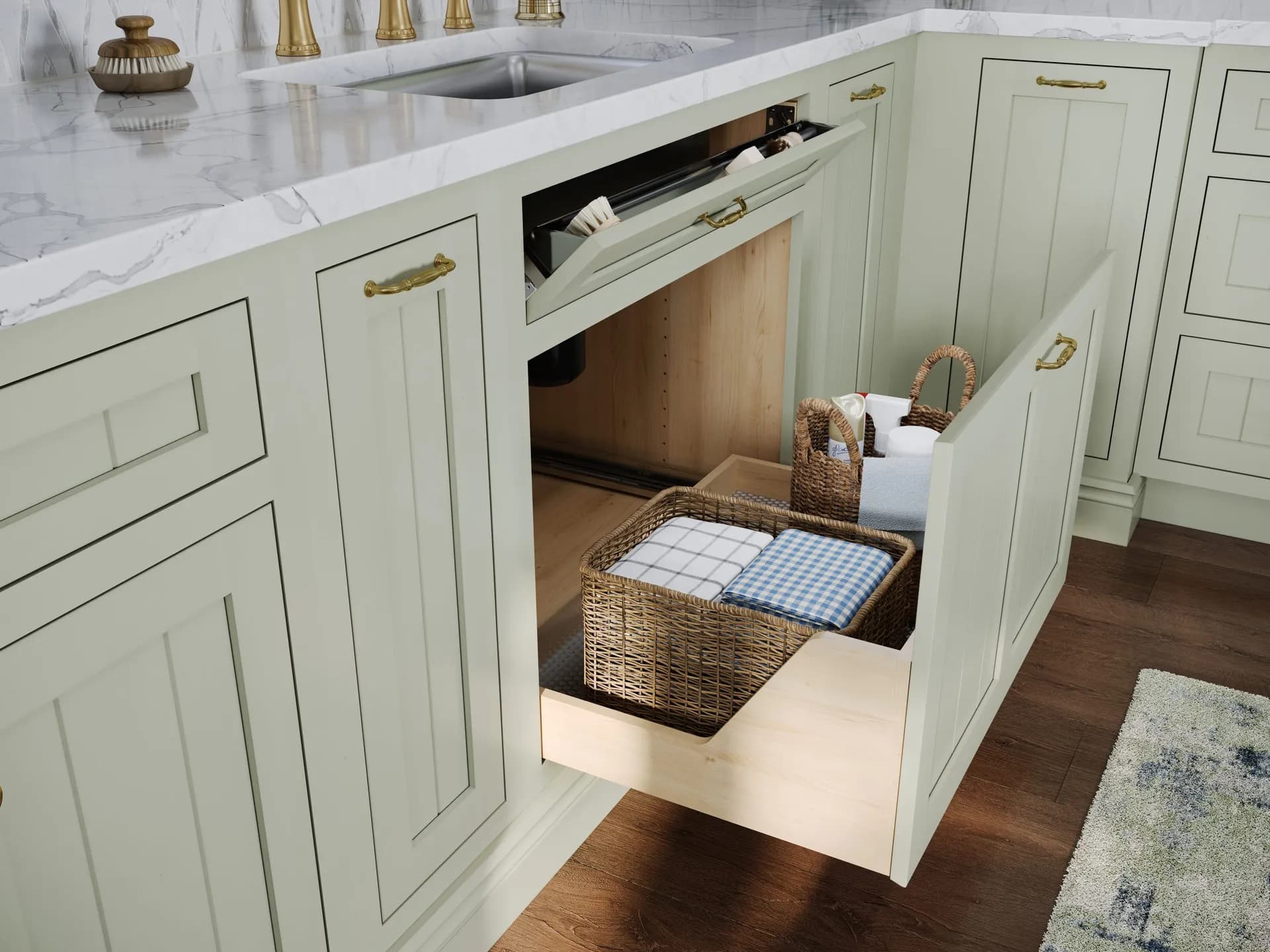 A sage-green Medallion kitchen with the sink-base pull-out drawer open, baskets and towels organized inside