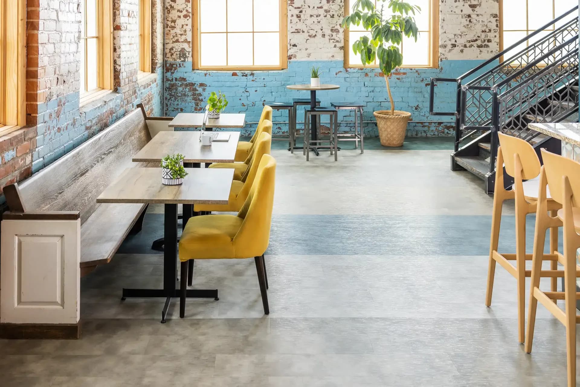 Wood-look and colored LVT in a restaurant dining room — flooring for Polk County, FL businesses