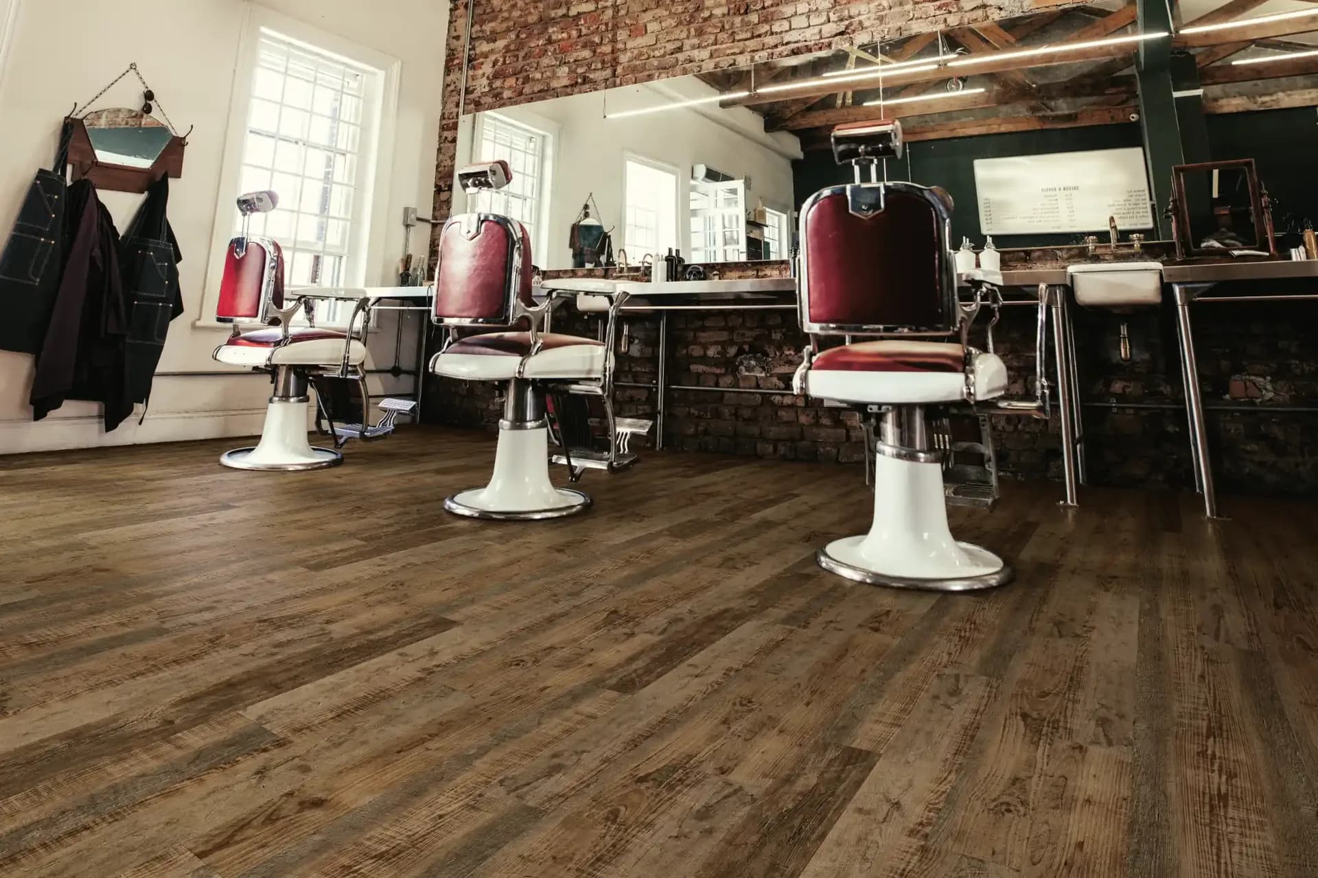 Distressed wood-look flooring in a barber shop build-out — contractor flooring in Polk County, FL