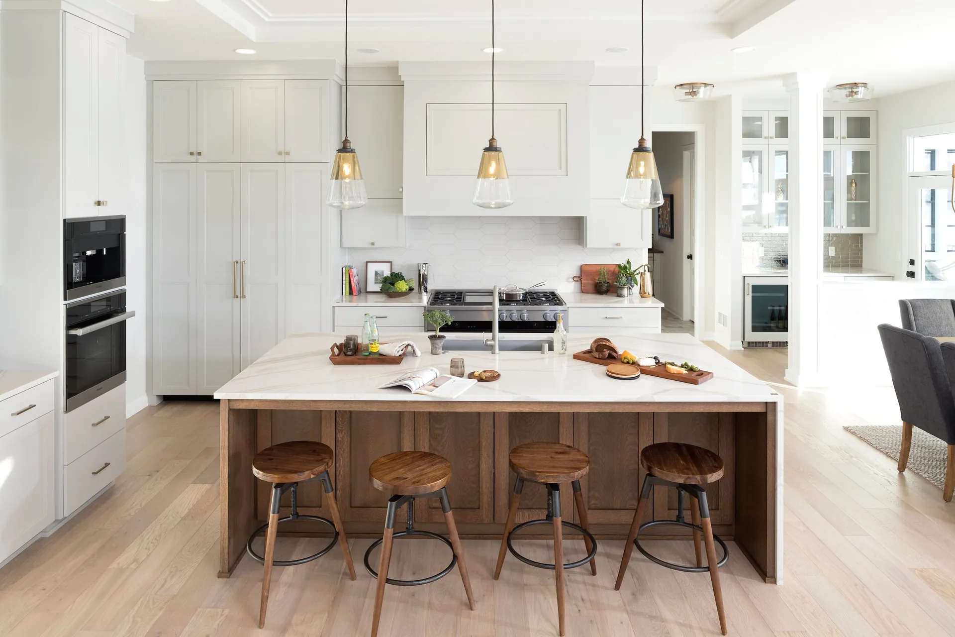 Cambria Brittanicca Warm quartz countertops with a wood island, from the Cambria line we carry