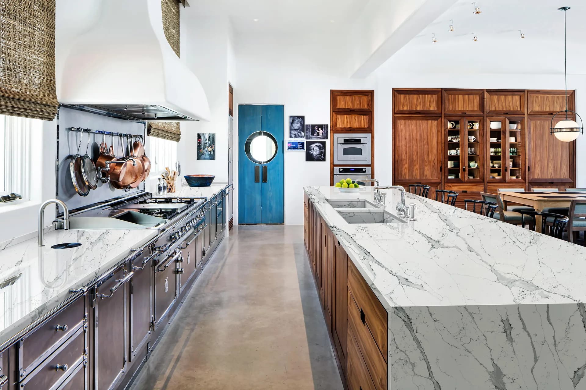 Quantum Quartz Calacatta Monet waterfall island with walnut cabinets, from the Quantum Quartz line we carry