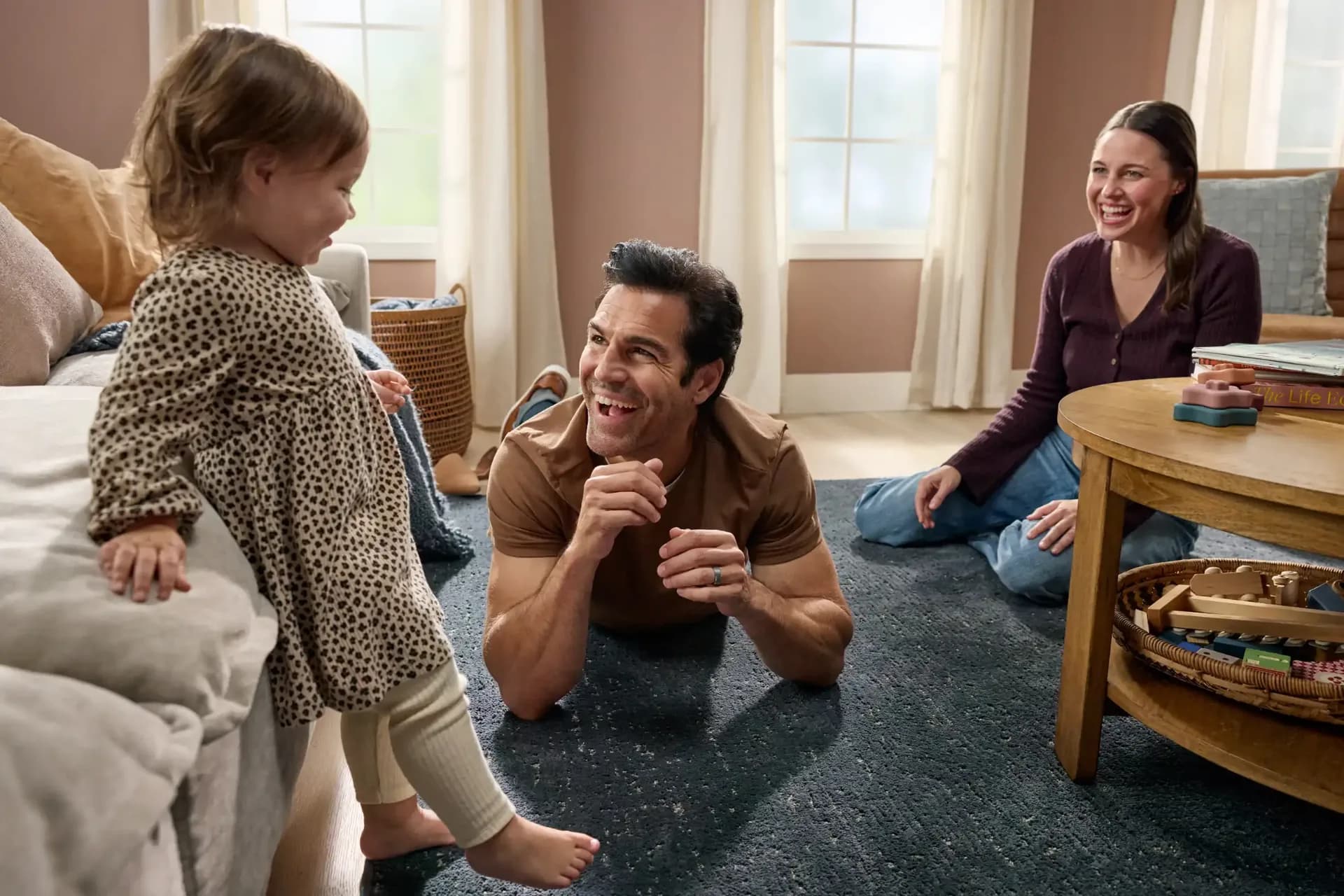 Family dancing on soft blue carpet in the living room — flooring financing FAQ, Winter Haven, FL