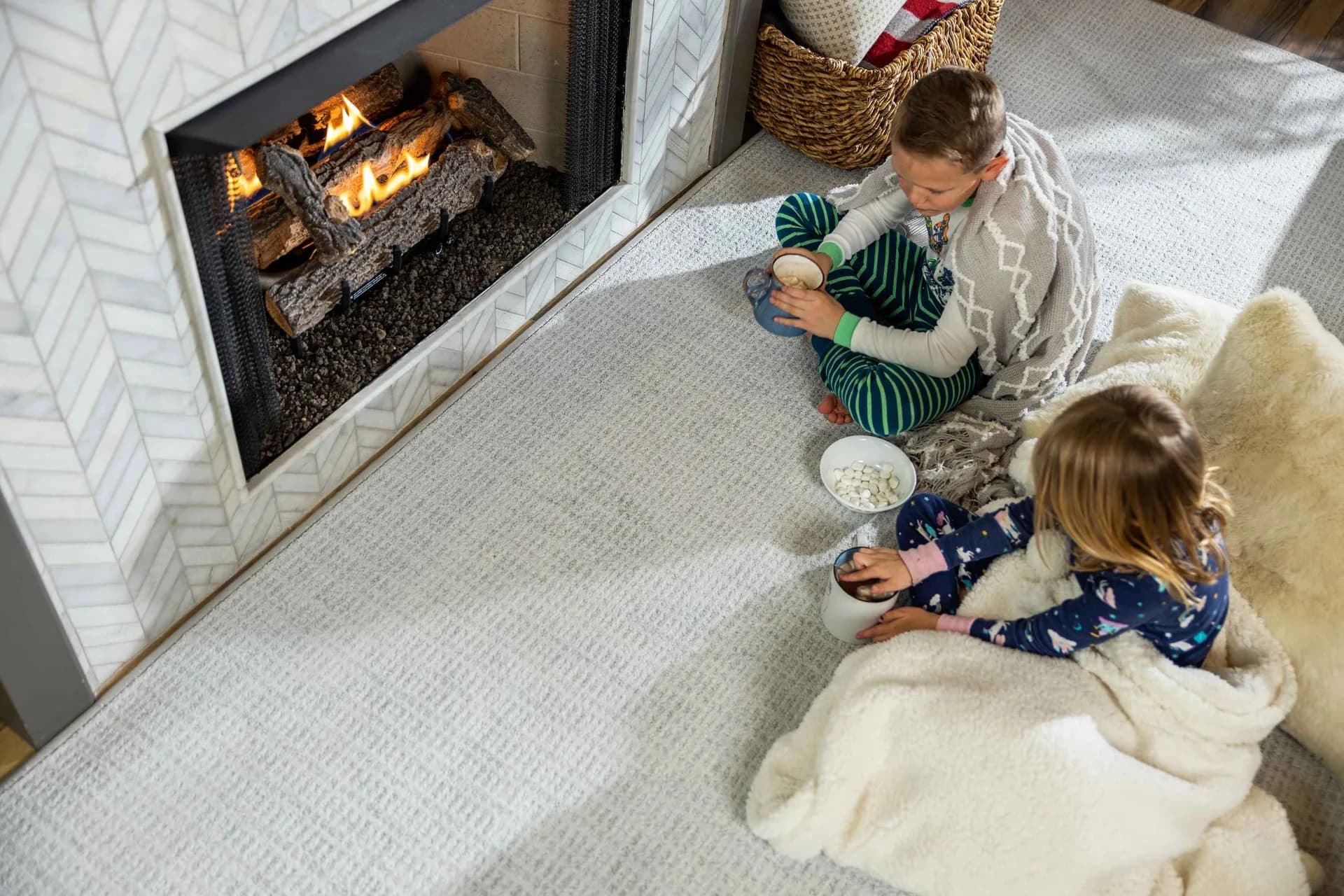 Kids with popcorn by a fireplace on plush carpet — flooring financing in Winter Haven, FL
