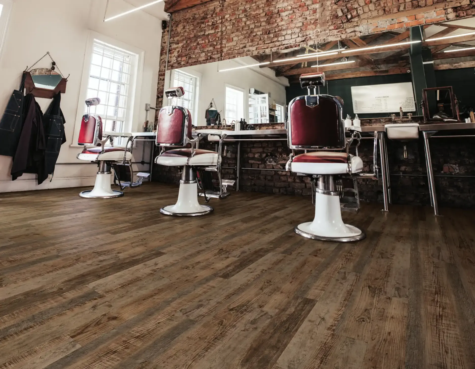 COREtec Pro Plus luxury vinyl plank in a working barbershop. Carried by Blackburn's Interiors, Winter Haven, FL