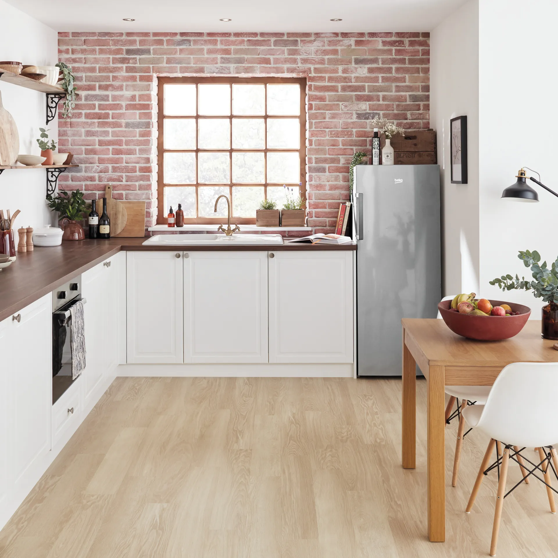 Karndean luxury vinyl plank in a kitchen with an exposed brick wall. Carried by Blackburn's Interiors, Winter Haven, FL