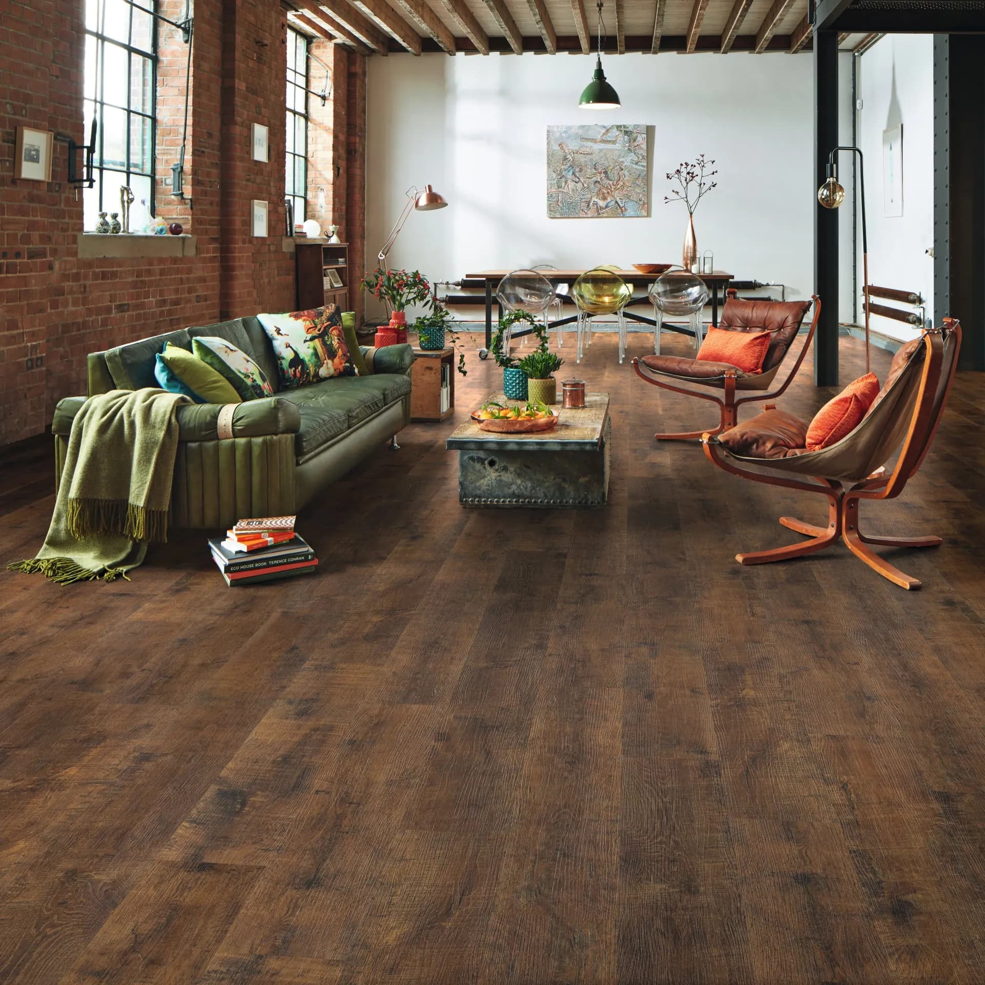 Karndean luxury vinyl plank in a loft living room with a green sofa. Carried by Blackburn's Interiors, Winter Haven, FL