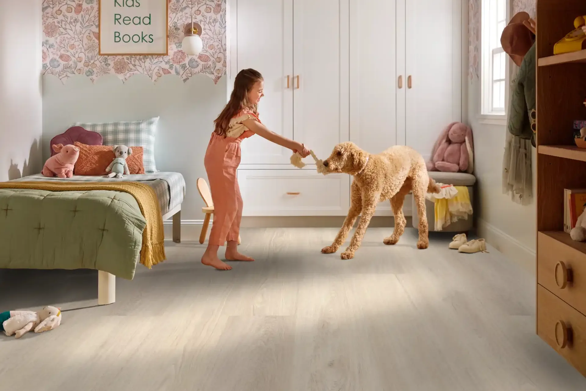 Girl and doodle dog in a kids' room on pale waterproof LVP — luxury vinyl plank for Lakeland, FL