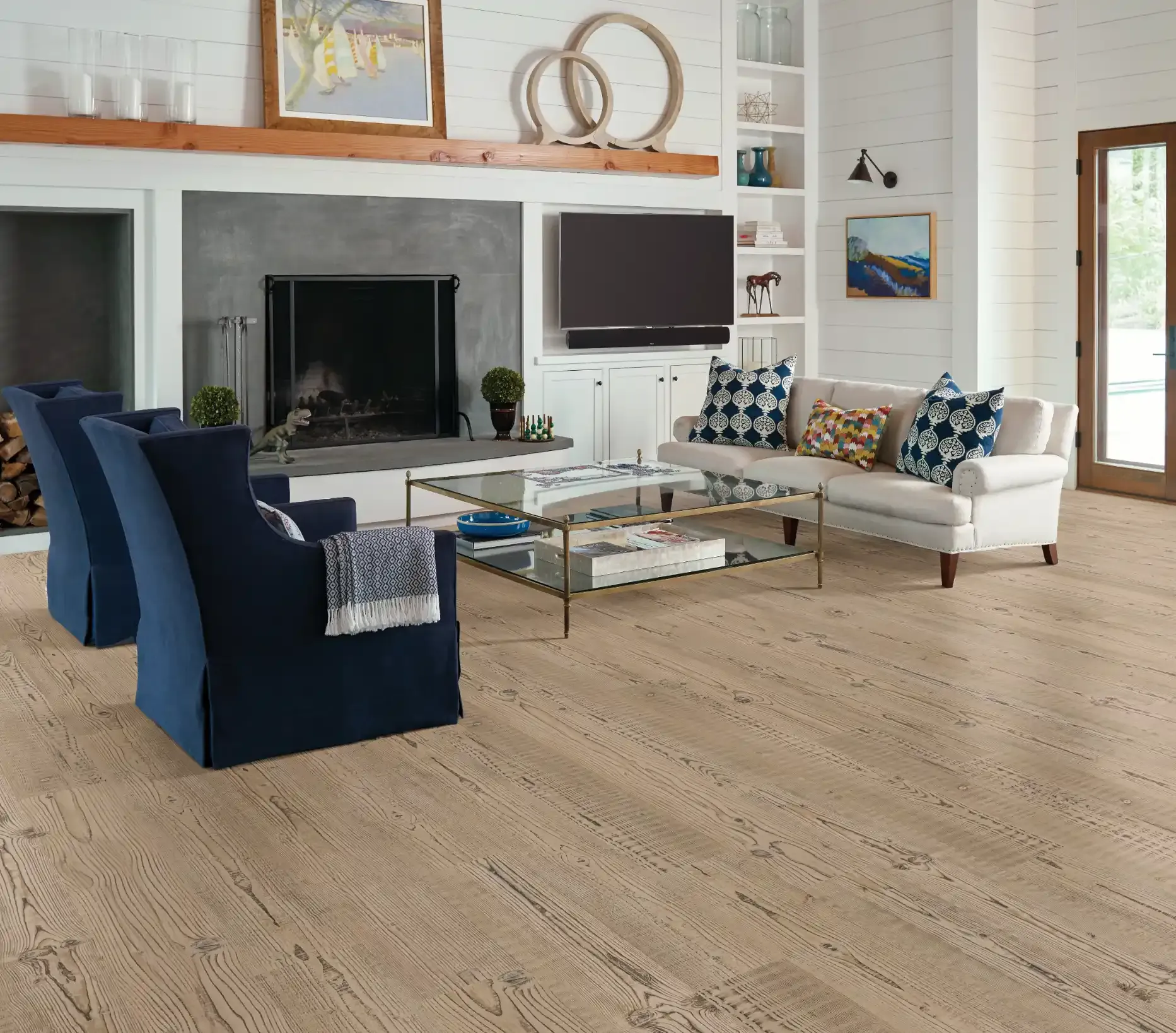 Shaw Anvil Plus luxury vinyl in Accent Pine in a fireplace living room. Carried by Blackburn's Interiors, Winter Haven, FL