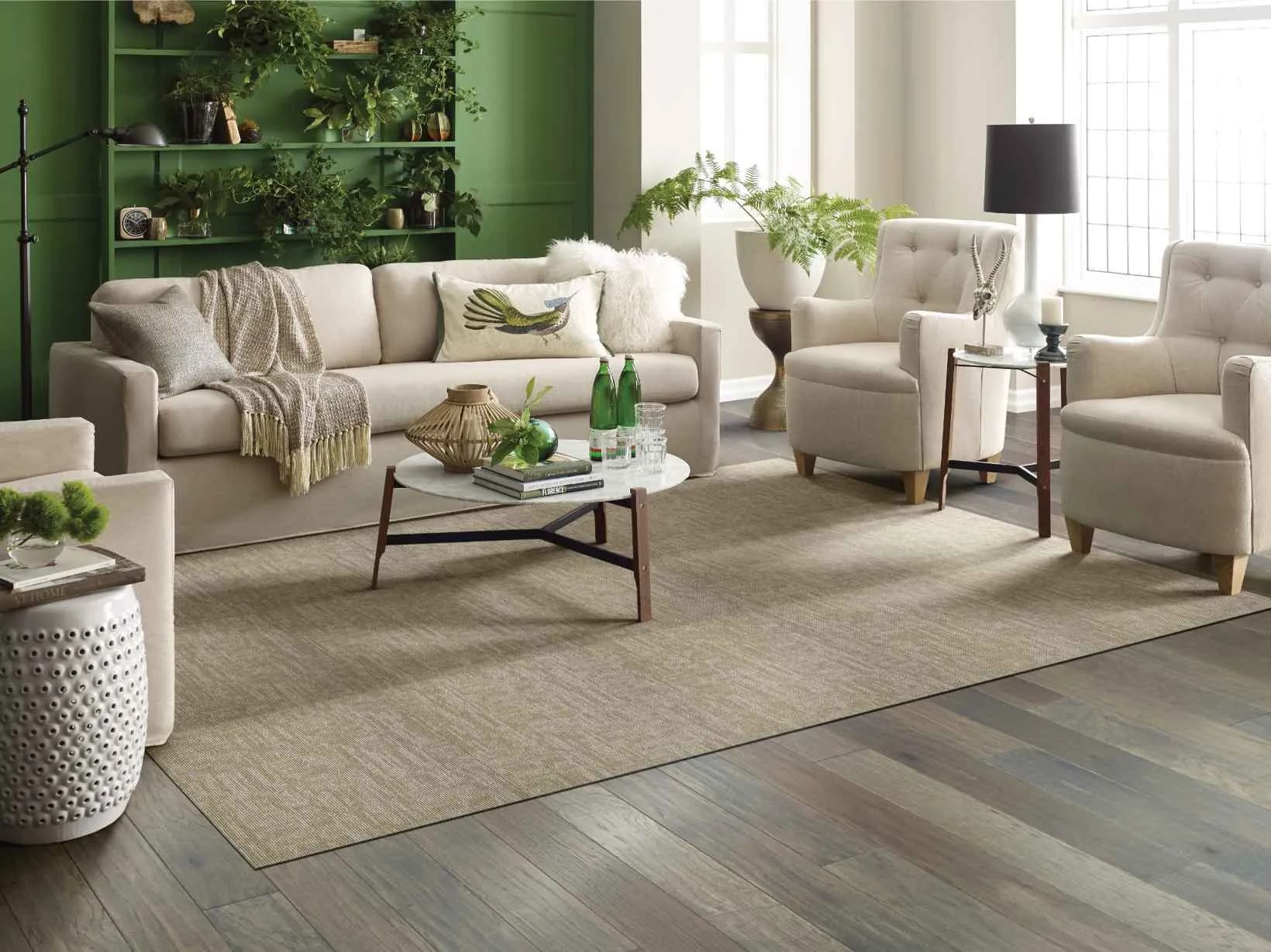 Shaw Carbon Copy flooring in a green plant-filled living room. Carried by Blackburn's Interiors, Winter Haven, FL