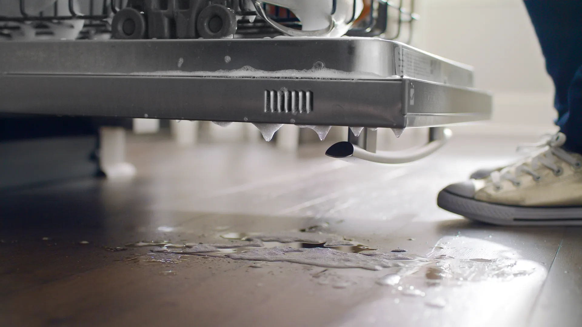Water dripping from a dishwasher onto Shaw Repel water-resistant hardwood. Carried by Blackburn's Interiors, Winter Haven, FL