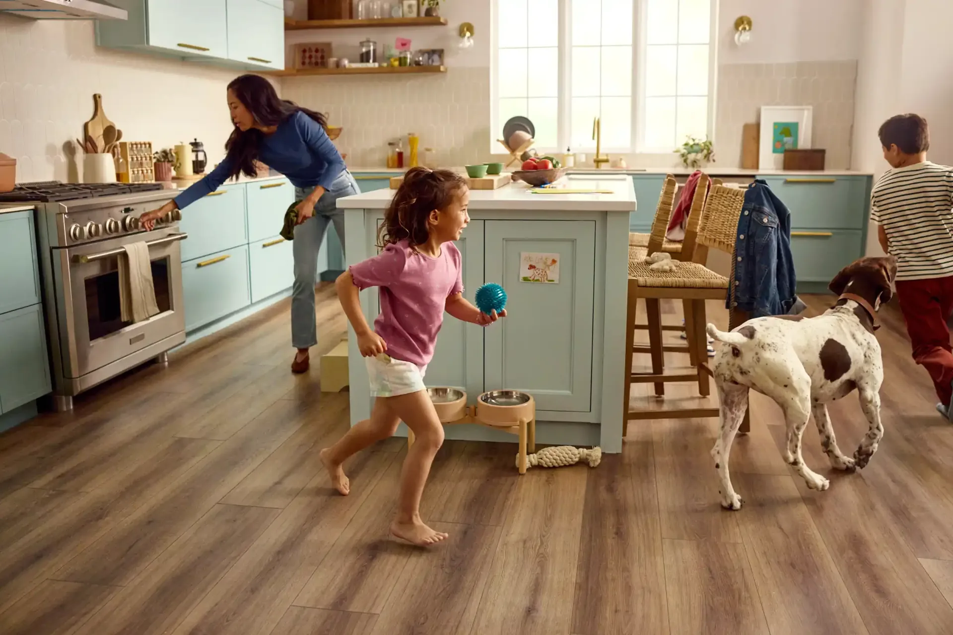 Dog and child playing on waterproof LVP in a kitchen — pet-friendly flooring for Winter Haven, FL homes