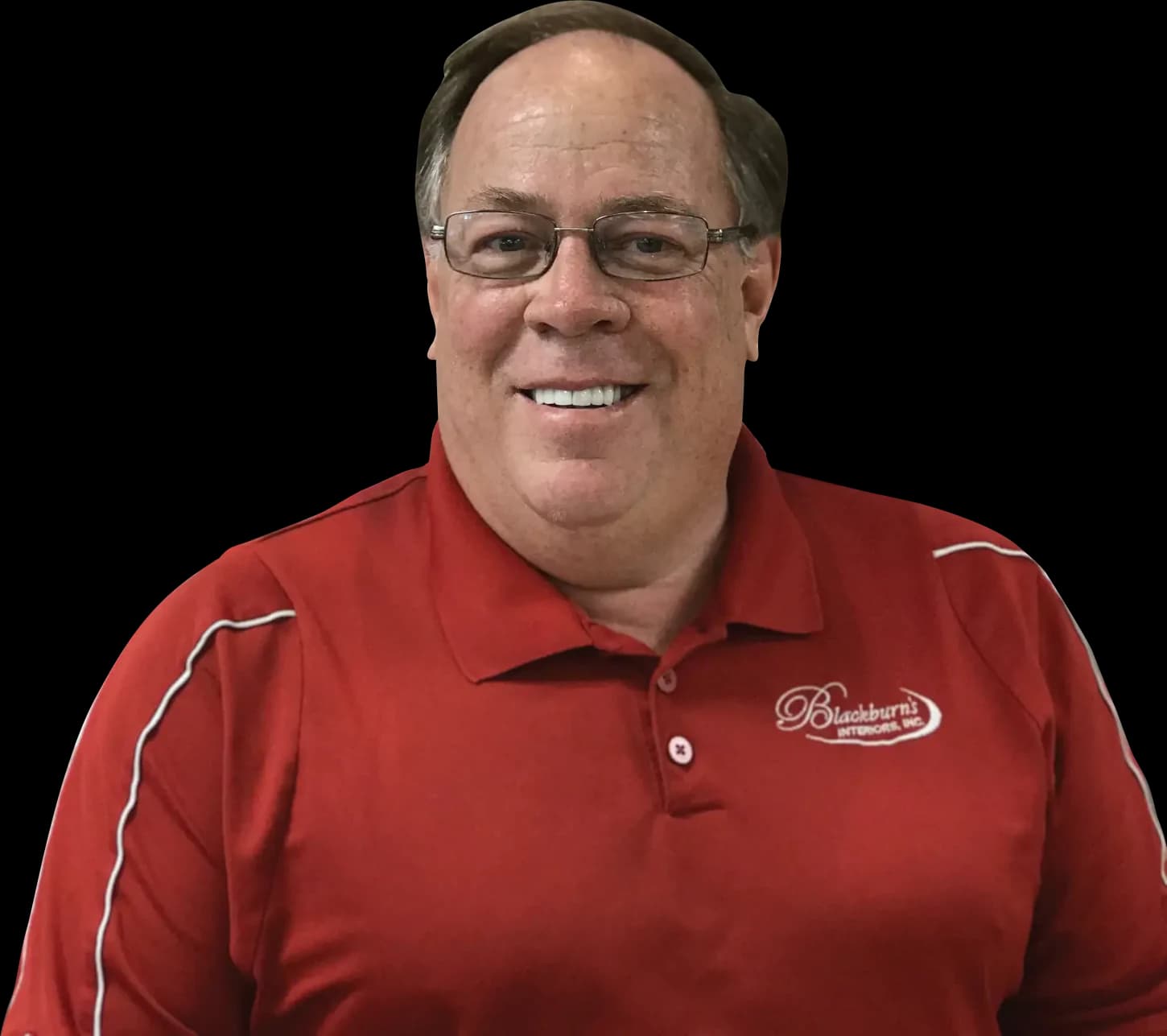 Wally Blackburn, second-generation owner of Blackburn's Interiors, in a red company polo shirt