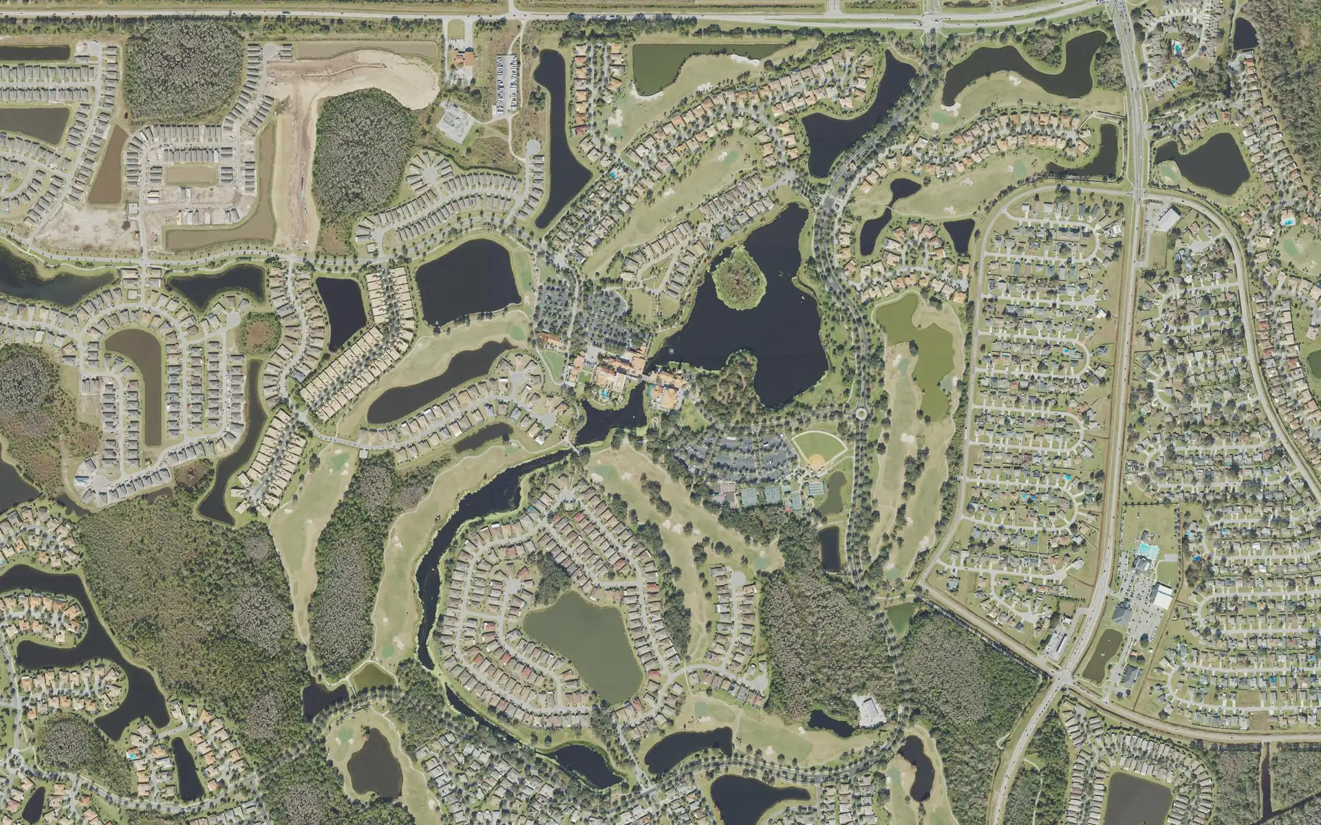 Aerial view of Solivita's neighborhoods, ponds, and golf courses in Poinciana, Florida