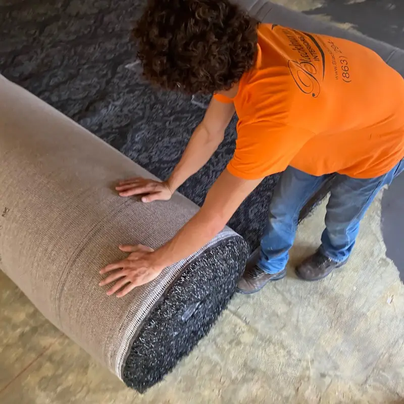 Installer unrolling the Shaw Floors patterned broadloom carpet over fresh padding at Arabella's Ristorante in Winter Haven, FL