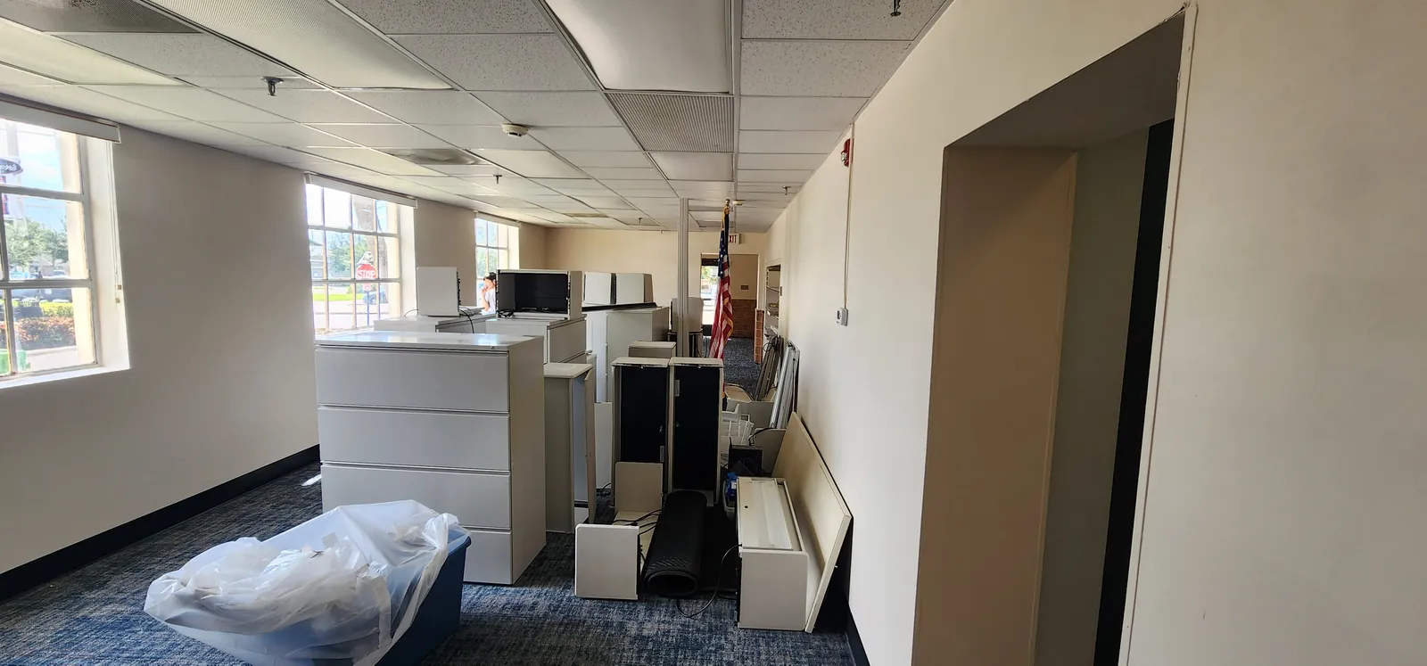 Long office run at the Federal Building recarpeted in Terrena tile, furniture moved to the wall for the install