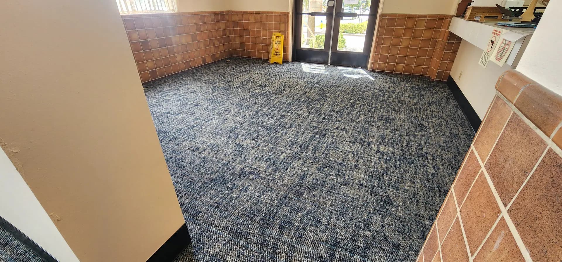 Philadelphia Commercial Terrena carpet tile in Alcove across the Winter Haven Federal Building entry, glazed block walls and glass doors beyond