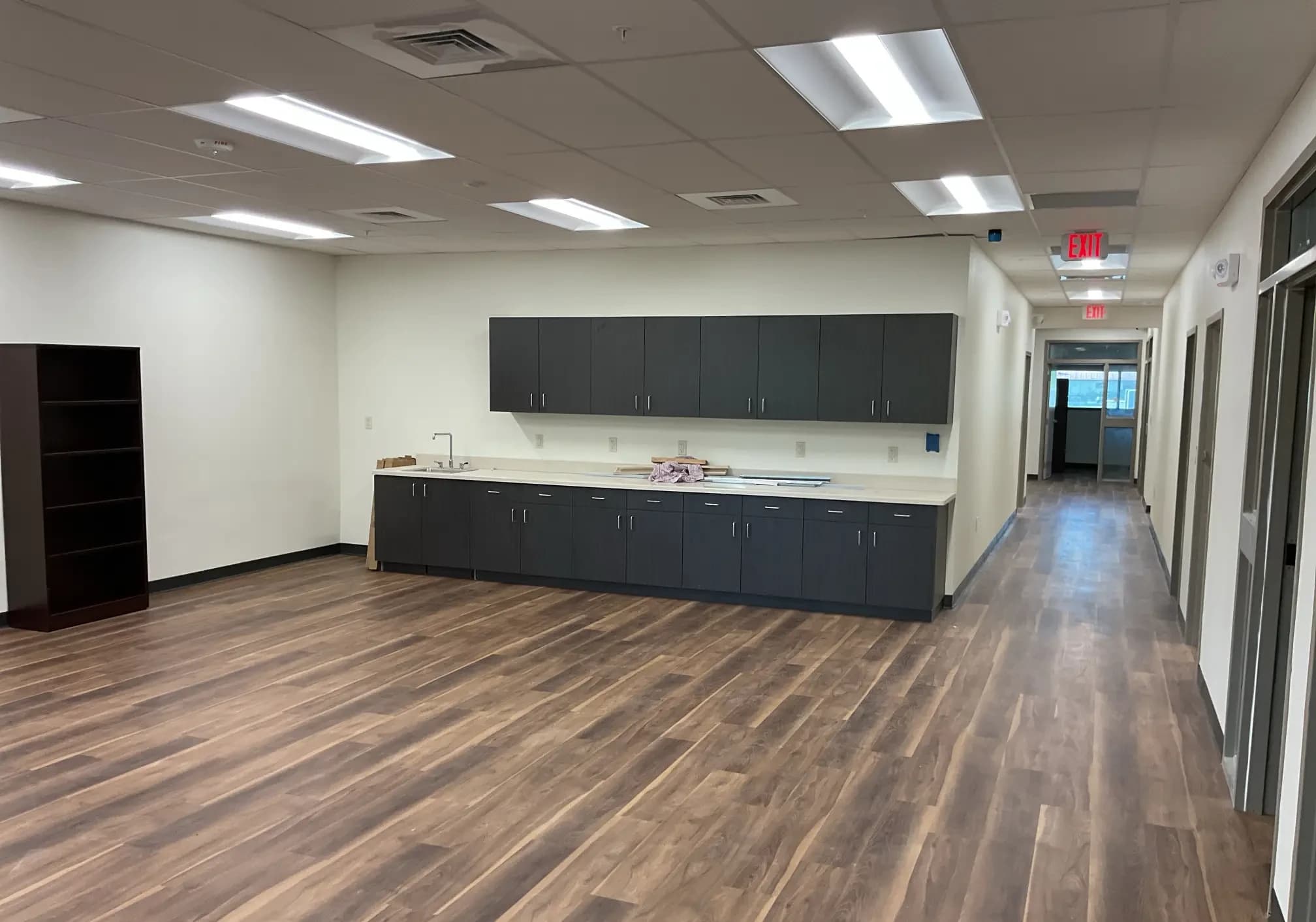 Wood-look flooring and dark casework in the break room at the DeSoto County Admin Building