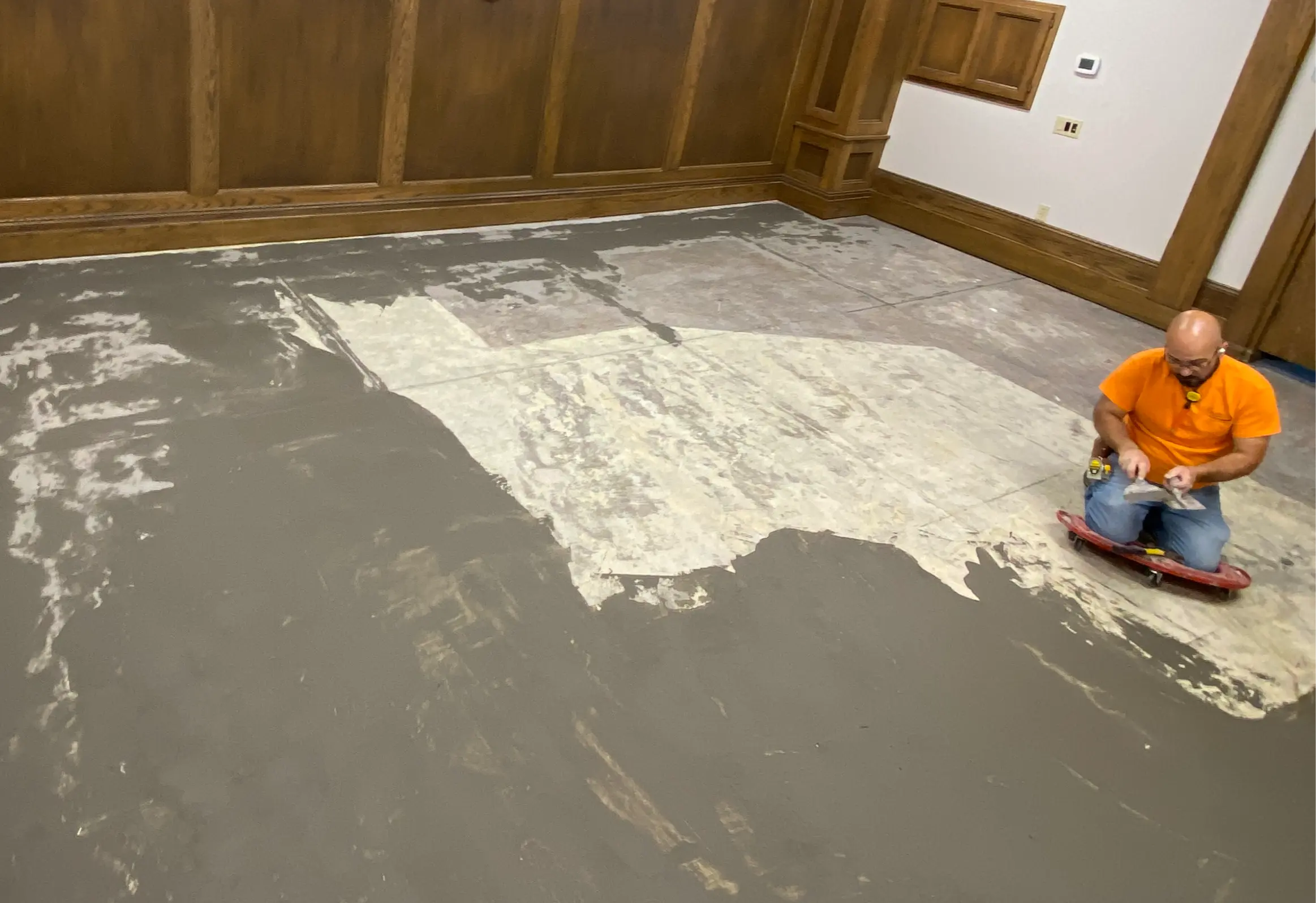 Skim-coating and prepping the courtroom subfloor at the DeSoto County Courthouse after the old flooring came up