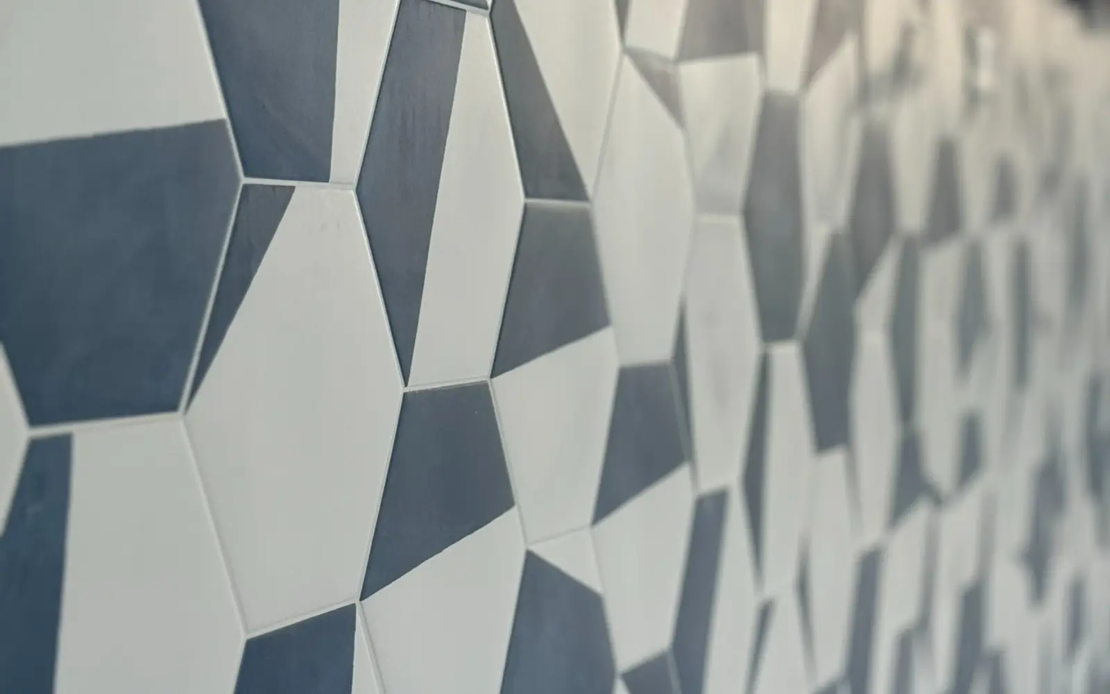 Close-up detail of the navy blue and white geometric hex porcelain tile on the Maritime bar front