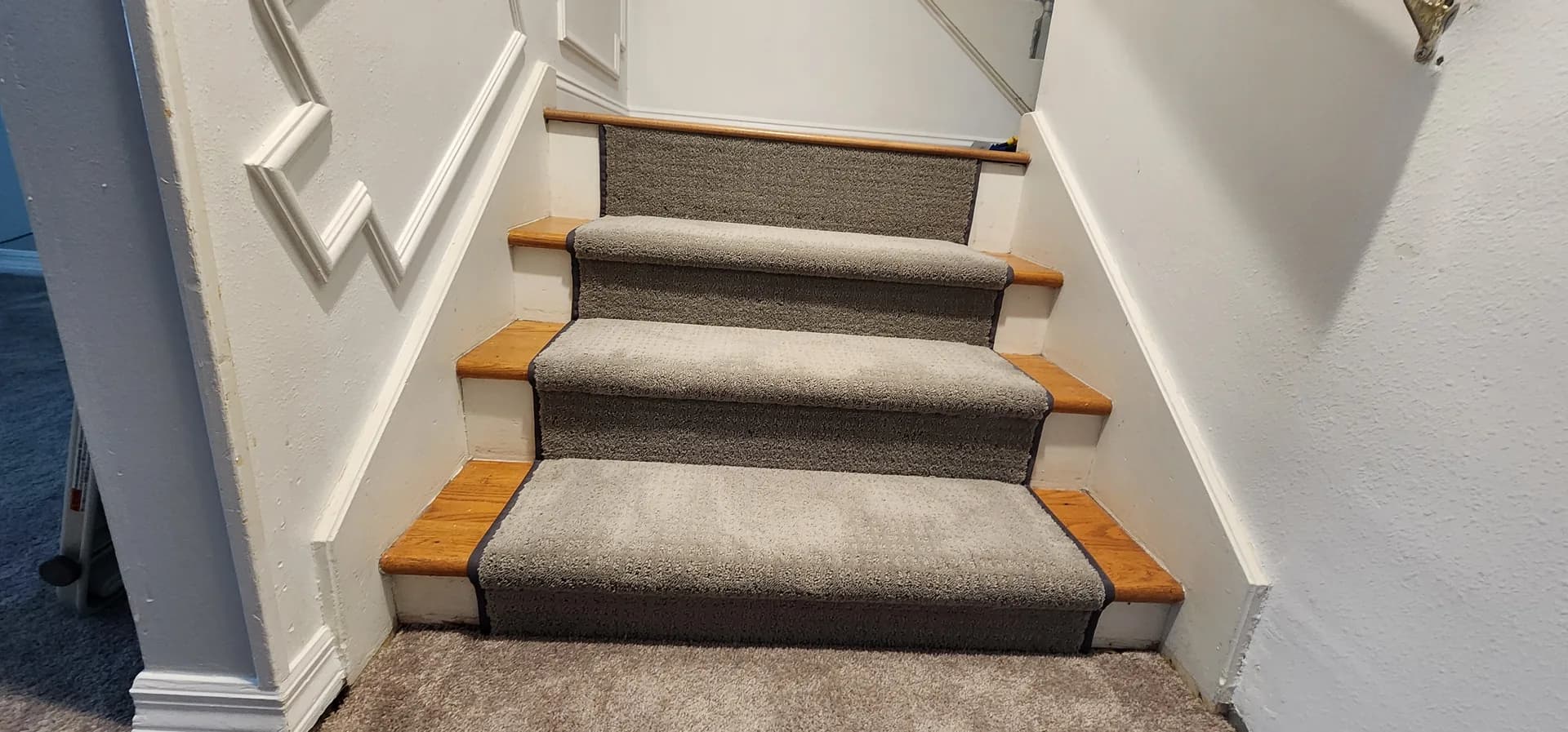 Shaw Floors Essential Now carpet runner in River Run over oak treads, looking down a Winter Haven staircase