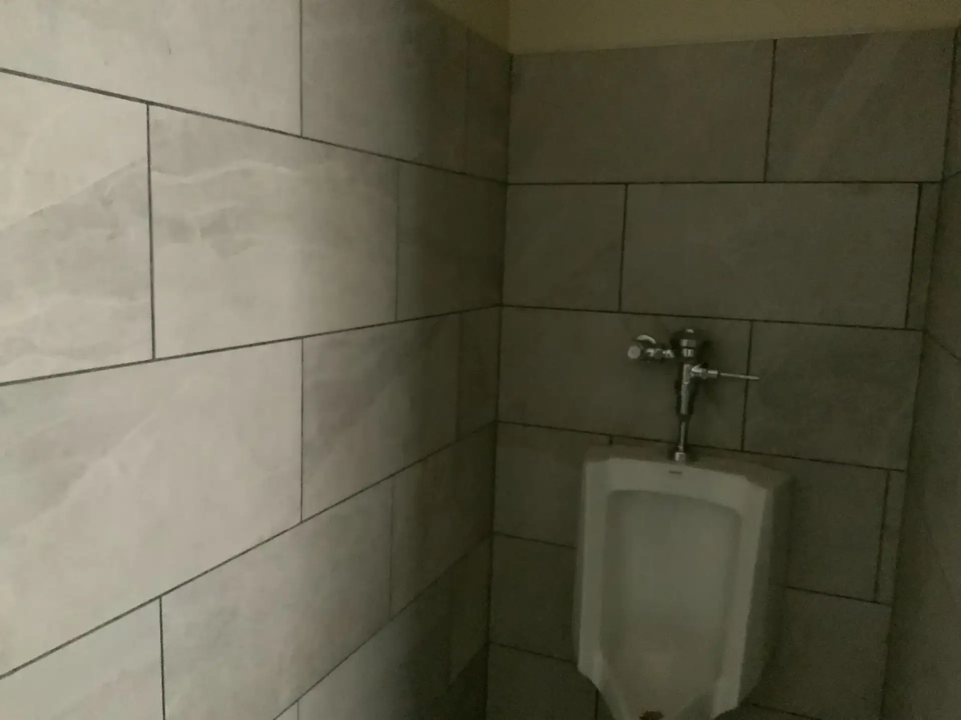 Detail of the gray porcelain wall tile and urinal rough-in at the new Winter Haven Fire Station #4 restroom