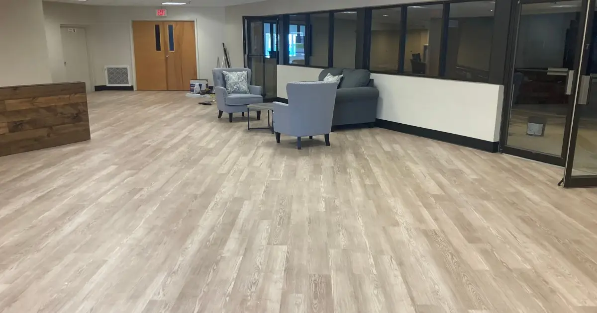 Light wood-look Shaw Floors luxury vinyl plank in the lobby of Winter Haven Nazarene Church with the sitting area and sanctuary windows behind